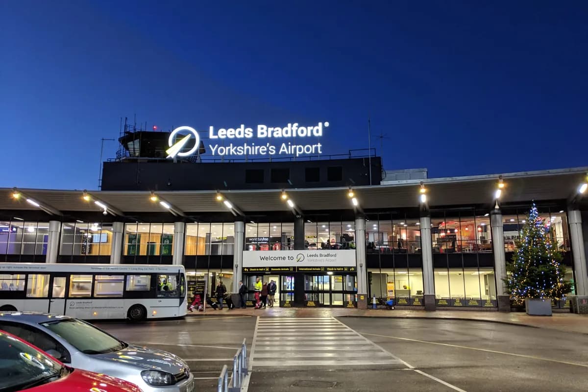Leeds Bradford Airport terminal entrance at dusk — Ridecore Travel transfers from Leeds